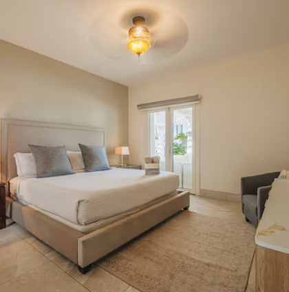 Villa bedroom with king bed and terrace access