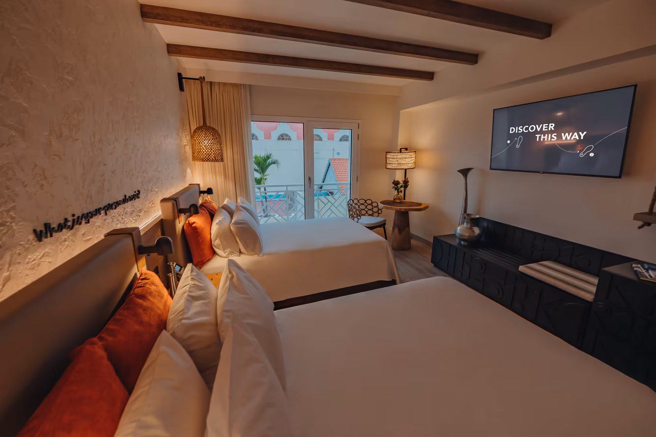 Double queen resort-view room with white linens and a marina-side outlook