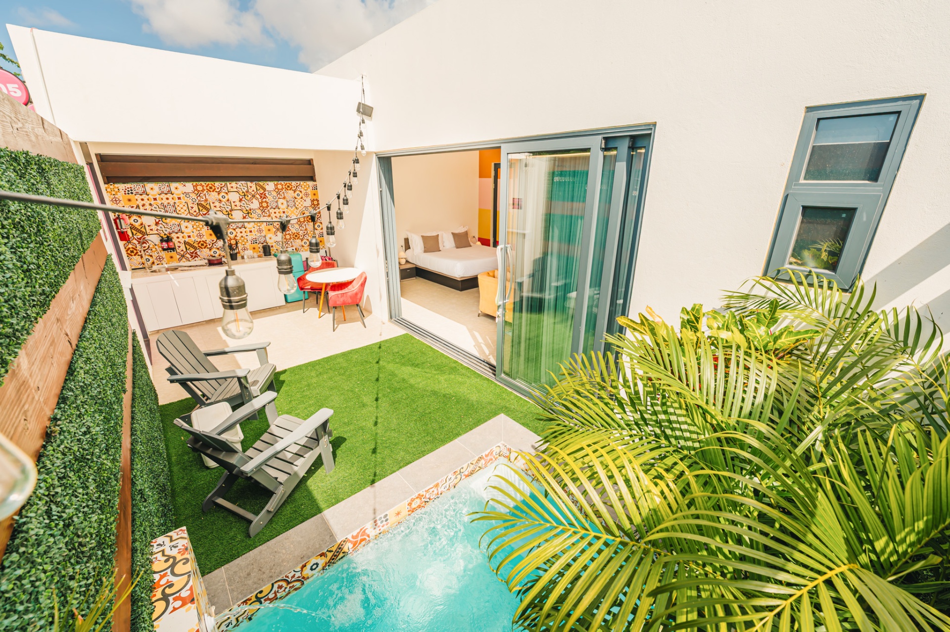 Private plunge pool steps from a Privada guest room, surrounded by patterned tile and palms